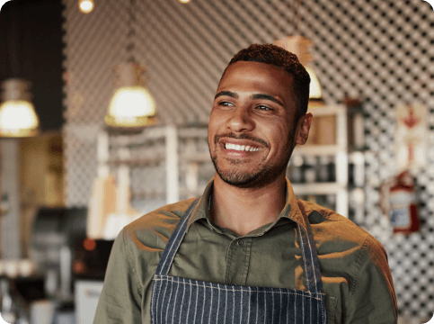 Man wearing an apron in a restaurant